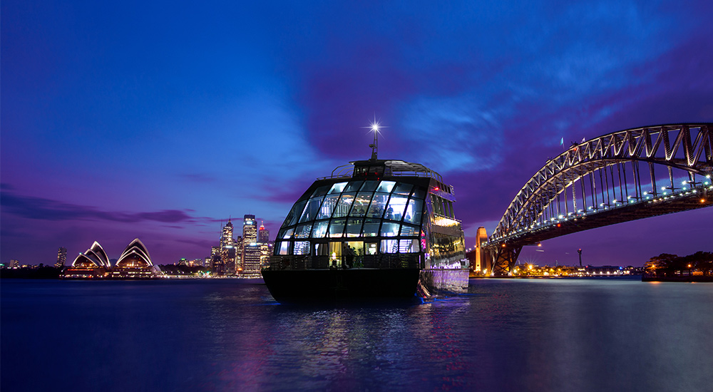 Clearview glass boat dinner cruise with the Sydney Harbour Bridge and Opera House behind